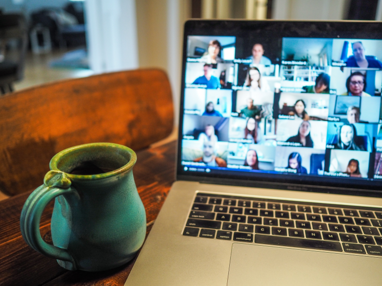 A teacher leading an online class, seen on a laptop screen
